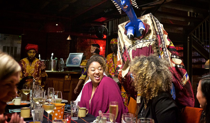 A group having a good time at GOLD restaurant in Cape Town.