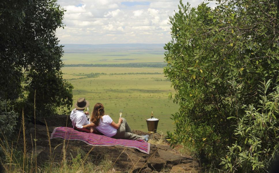 Two guests enjoy an intimate picnic on the crest of the Out of Africa kopje.