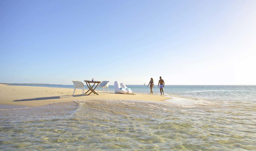 After snorkelling, a couple arrive at Pansy Island for a tantalizing picnic lunch. This Pansy Island is an isolated sand-bar nestled between Bazaruto Island and the Mozambique Channel. 
